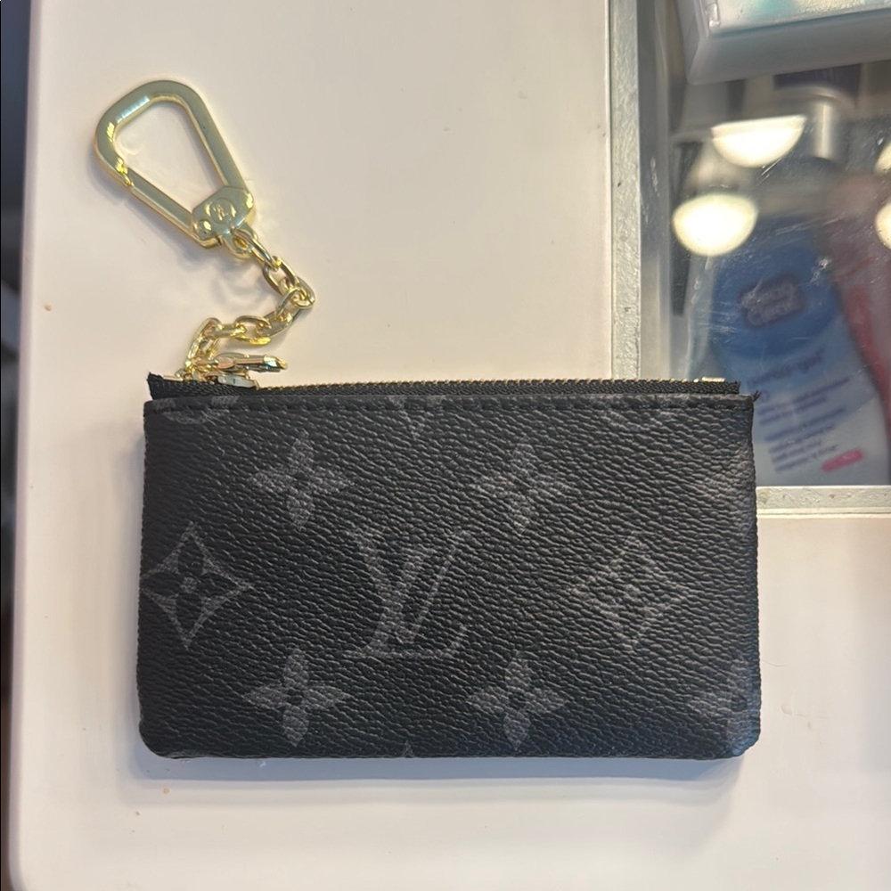 Louis Vuitton Black and Gold Key Holder with Monogram Design